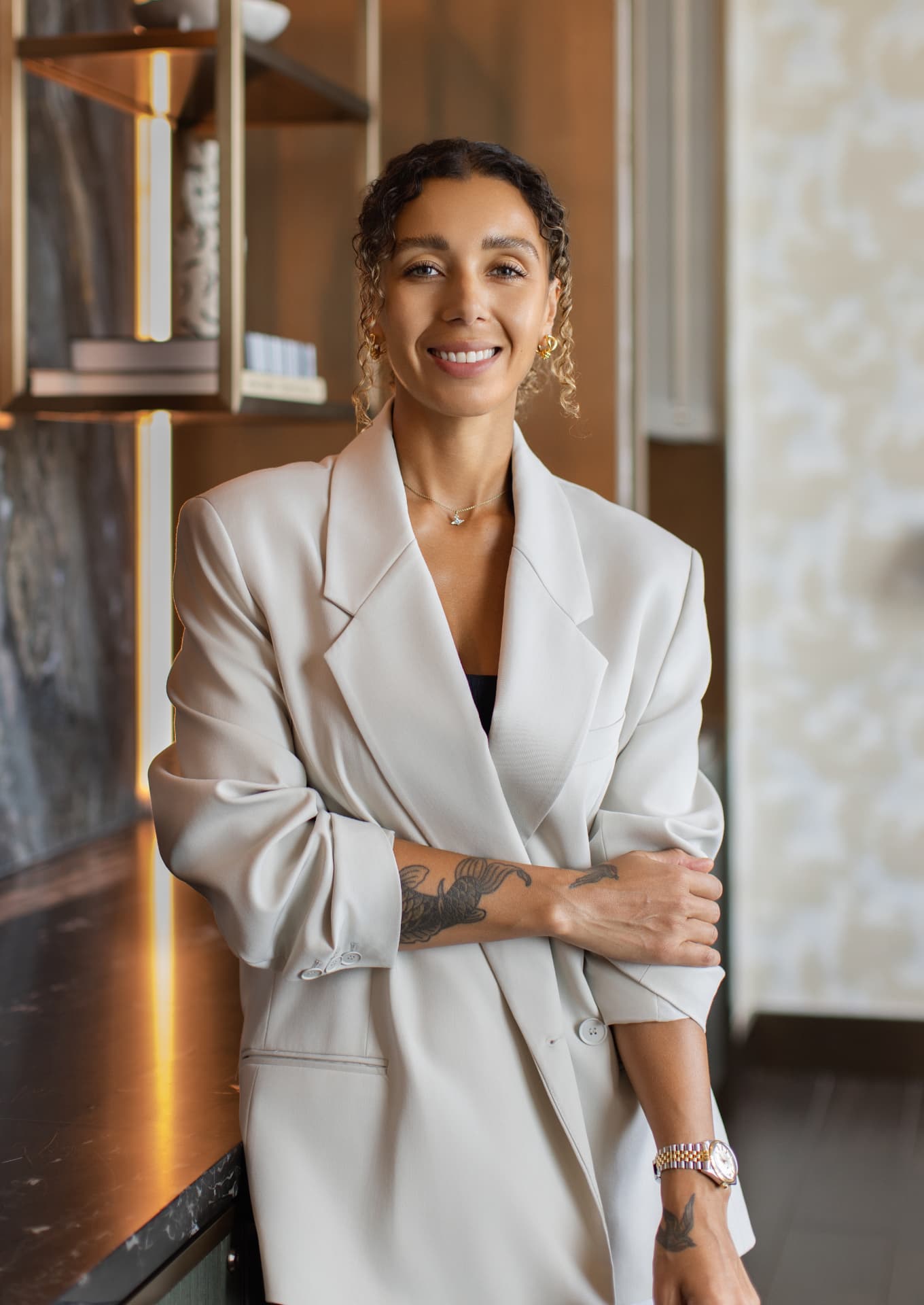 Charlene Marshall, founder of Studio Tenth, in a cream blazer in a warm interior